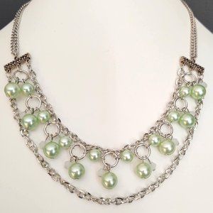 Silver necklace with green beads and white accents